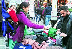 A woman purchases warm clothing in Srinagar