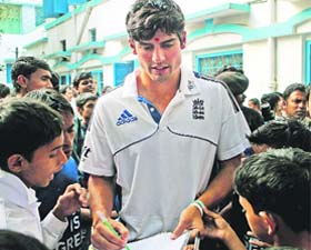 England cricket captain Alastair Cook signs autographs at a home for street children in Kolkata on Saturday