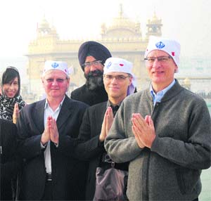 Canadian High Commissioner to Pakistan Greg Giokas (right), and South Asia Relations (GSB) Director Graeme Mclntyre (centre) pay obeisance at the Golden Temple in Amritsar on Sunday.