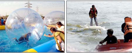 Theres surely no better way of spending a sunny Sunday afternoon in winters than enjoying water sports. And Bathinda residents did just that! (Left) Visitors try and touch a zorbing ball at the adventure sports carnival at the Thermal Lake in Bathinda on Sunday. A young girl (right) tries to balance herself while enjoying water gliding at the carnival.