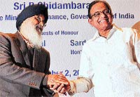 Punjab Chief Minister Parkash Singh Badal (left) and Finance Minister P Chidambaram shake hands at the Indian School of Business in Mohali on Sunday