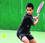 A player returns a shot during the AITA Championship Series Tennis Tournament at the CLTA in Chandigarh on Sunday