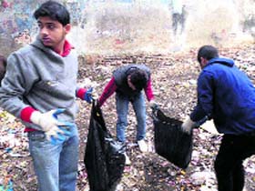 Volunteers of MAD, a social organisation, participate in a cleanliness drive near Krishna Palace in Dehradun on Sunday.