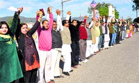 Workers of the RSS and the Vishwa Hindu Parishad form a human chain for the cause of Ganga cleanliness at Har-ki-Pauri in Haridwar on Sunday.