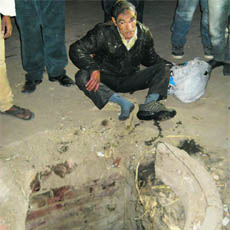 Watchman Kharak Singh after being pulled out of an open manhole in Sirsa. 