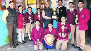 Principal Sudhanshu Sharma, winners of Green Field Senior Secondary School, Nagrota Bagwan, and Tilak Raj Rana, teacher-guide, with trophies. 