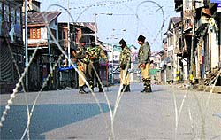 Paramilitary personnel stand guard in downtown Srinagar on Sunday