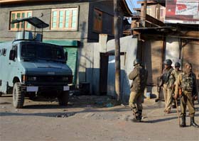 Paramilitary personnel stand guard in downtown Srinagar as curfew was imposed in the city.