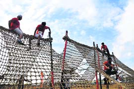 Residents cross a hurdle. near Sidhwan Canal in Ludhiana on Sunday.