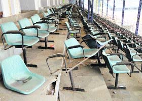 Broken chairs lie scattered at the VIP block at the Guru Nanak Stadium.