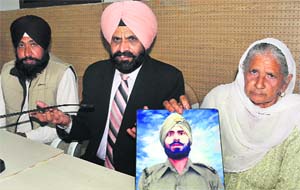 Ajaib SIngh (centre), member of the National Commission for Minorities, with Baljeet Kaur, wife of sepoy Jaspal Singh who has been missing since 1971, and her son Kamaljeet Singh in Chandigarh on Sunday.