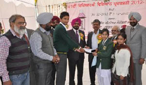 Chief Parliamentary Secretary Sarup Chand Singla and IG Nirmal Singh Dhillon give away the award to the winning students on the concluding day of the 41st state-level science fair at Baba Farid Institute, Deon, on Monday. 