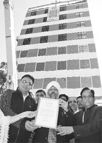 Harpal Singh (in turban) receives the national record certificate in Mohali on Monday. 