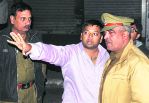 Businessman Nikhil Bansal narrates the robbery incident to police officials at Mani Majra on Monday.
