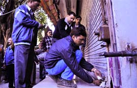 MDDA workers seal a shop in Dehradun on Monday.