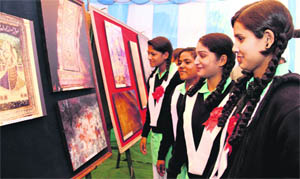 Students at the photo exhibition at the science branch of the Archaeological Survey of India in Dehradun on Monday.