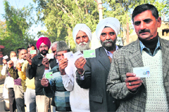 Sarpanches and panches show their identity cards before casting the vote for the Legislative Council elections under panchayat quota on the outskirts of Jammu on Monday. Tribune photo: Inderjeet Singh