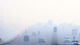 Road to nowhere? Vehicles cross a flyover in thick fog on the Jalandhar-Amritsar national highway on Monday morning