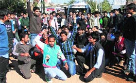 Students of Polytechnic College along with local residents protest on the Jammu-Akhnoor road on Monday.
