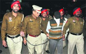 Micky Jain, prime accused in the Reema Jain murder case, comes out of a court in Ludhiana on Monday