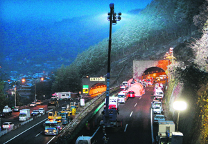 Ambulance and construction vehicles parked outside the Sasago tunnel in the city of Otsuki.