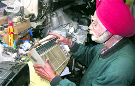 Thukral, owner of Thukral Brothers, still repairs radios at his shop in Mussoorie.