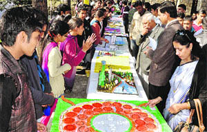 Students explain their models to visitors at a science exhibition at Government PG College, 