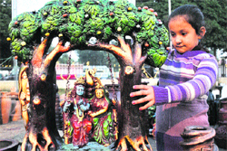 A girl checks out an item on display at an exhibition-cum-sale organised by the Information Department at 