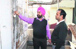 MC officials seal the mobile towers installed on top of the building of Raghunath Hospital near Aggar Nagar in Ludhiana on Tuesday. Photo: Inderjeet Verma 