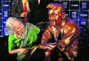 Veteran actress Waheeda Rehman takes a closer look at a life-size statue of legendary actor Dev Anand after its unveiling to mark his first death anniversary in Mumbai on Tuesday