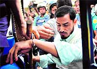 The police detains an activist of Jamaat-e-Islami during a nationwide strike in Dhaka on Tuesday