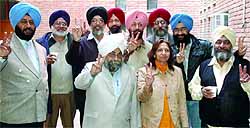 Members of Radical Teachers Front flash a victory sign after winning the GNDUTA elections in Amritsar on Wednesday