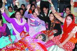Jasbir Kaur (lying), who was on hunger strike, is back on the stir path. Tribune photo: Pawan Sharma