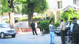 Officials of the MC enforcement wing outside the residence of MP KD Singh in Sector 9, Chandigarh, on Wednesday. 