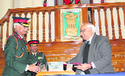 Commandant, IMA, Lt Gen Manvender Singh, and VC of Uttarakhand Technical University DS Chauhan exchange documents in Dehradun on Wednesday. A Tribune photograph