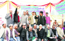 Members of the Uttarakhand Kranti Dal (D) stage a dharna outside the Vidhan Sabha in Dehradun, demanding permanent capital status for Gairsain on Wednesday. Tribune photo: Vinod Pundir