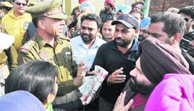 Property owners at Kuki Dhab argue with policemen accompanying the demolition team of the MC in Jalandhar on Wednesday