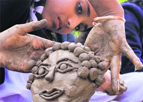 Students participate in a clay modelling competition organised by Viraj Kala Kendra in Jammu on Wednesday