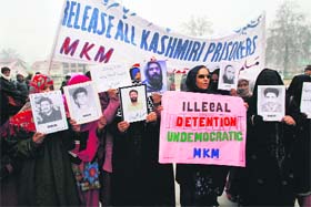 Members of the Muslim Khawateen Markaz hold a protest demanding release of Kashmiris lodged in jails on Wednesday