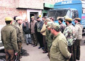 Police officials stop Hardline Hurriyat chairman Syed Ali Geelani from moving out of his house in Srinagar on Wednesday