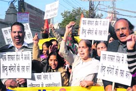 Prof Laxmi Kanta Chawla and her supporters stage a protest at the Attari-Wagah joint check post near Amritsar on Thursday