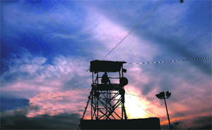 Myriad hues of the setting sun add to the beauty of City Beautiful while a policeman atop a watchtower keeps a vigil during Crafts Mela at Kala Gram on Thursday.