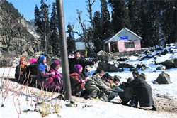 Children play over snow in south Kashmir on Thursday. Tribune photo