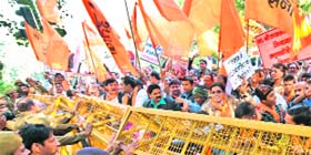 The police holds back Hindu Rashrawadi Sena activists during a protest in New Delhi on Thursday
