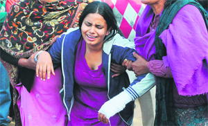 Robinjeet Kaur breaks down at her house in Rampura village on Thursday.