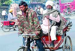 With mercury going down, people cover themselves with woollens as a preventive measure against cold, in Bathinda