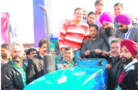 Industry Minister Anil Joshi sits on a tractor during PITEX-2012 at Amritsar on Friday.