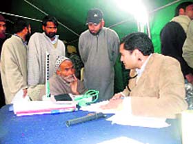 A doctor examines patients at a medical camp.