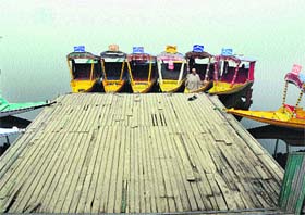 A boatman rest in his Shikara on the Dal Lake in Srinagar on Friday.