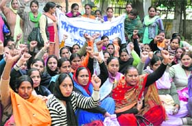 ASHA workers hold a protest outside the Civil Surgeons office in Ludhiana on Friday.